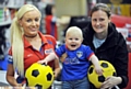 COMIC STRIP: Athletic’s new home kit for next season went on sale at the Sports Direct store in town yesterday - and there to snap up a shirt for smiling 10-month-old Emily Finnegan was mum Sarah, pictured with sales assistant Natalie McAiney.