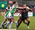 OLDHAM’S Steve Roper takes a blow to the face as he tries to burst through the Keighley Cougars line of defence. 
