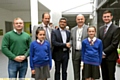 ALL smiles . . . (back, from left) Mike Hamilton, of Commando Joe’s; William Lees-Jones, managing director of JW Lees Brewery; Simon Arora, from B&M Bargains; Mahdlo chairman Terry Flanagan and Councillor Jim McMahon. Front:Alisha O’Connor and Lucy Haynes from St Thomas’ School, Leesfield