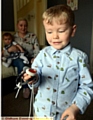 LITTLE life saver... Jack Griffin (3) with the emergency response button he uses to get help
