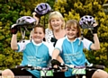 ON their bikes: Holly Taylor (left) and Katie Bissett with grandmother Maureen Oxley