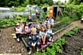 DEVASTATED . . . the Garden Gang from St Thomas’s School at the allotments. Teacher Karen Jakeman, back left, and parent Amirah Khan, back right, with children including, front from left, Jake Hacking, Frankie Birch and Heidi Verity. 