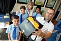 LIFESAVING kit: Paul Moss (right) with the defibrillator and (from left) Ethan Moss, Elysia Kay-Davies, headteacher Barbara Morris and Hamza Ishtiaq.