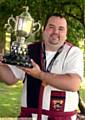 JUST CHAMPION . . . Michael shows off the English Open DTL trophy.