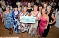 A YEAR of fundraising . . . Helen Haigh (front, left) presents £12,000 cheque to Maria Bramley, consultant breast surgeon at Victoria Breast Care Unit