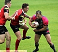 BEST FOOT FORWARD: Oldham’s Adam Neal confronts two Crusaders defenders.