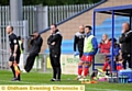 FOOD FOR THOUGHT . . . Athletic boss Darren Kelly views last night’s action, while trialists Jimmy Keohane (yellow top) and Jack Mmaee (yellow boots) look on. 