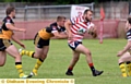 ON THE CHARGE FOR OLDHAM . . . two-try man Josh Crowley attacks the York City Knights line.