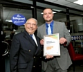 Norman Stoller presents a Get Oldham Working ambassador certificate to Ben Ingham of Safeguard Group during the event