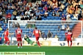 SURE STOP . . . David Cornell dives to his right to keep out Adam Clayton’s seventh-minute penalty. 