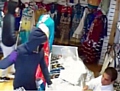 CAUGHT on camera . . . the knifemen burst into the shop