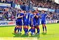 CELEBRATION TIME . . . team-mates congratulate penalty hot-shot Liam Kelly.
