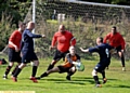 BRAVE STOP . . . Crown goalkeeper Mark Pellowe saves in a crowded goalmouth.