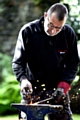 MASTER at work: blacksmith Simon Reed at work outside the Authentic gift shop, in Uppermill Picture by TIM BRADLEY