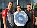 SHOWING THE SHIELD: Scott Naylor (left) with his assistant Lee Spencer (right) and Oldham chairman Chris Hamilton.