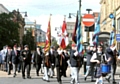 ON the march . . . the memorial parade makes its way through Oldham town centre
