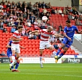 HIGH FLIER: Timothee Dieng leaps above the Doncaster defence to power a header towards goal. 