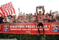 CHAMPIONS . . . Lewis Palfrey holds aloft the League One Championship Rose Bowl and Oldham Rugby players celebrate after their promotion play-off success against Keighley Cougars