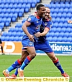 ALL-SQUARE . . . Dominic Poleon gets a hug from Lee Croft after equalising for Oldham on Saturday. 