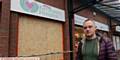 Darren Hunt, manager of Dr Kershaw's Hospice charity shop in Albion Street, Oldham shows where a raider smashed the front window during a break-in