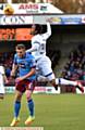 UP HIGH ... Charles Dunne rises above his Scunthorpe rival