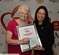 EDUCATION Worker Award winner Marlene Armitage (left) recieves her certificate from Debbie Abrahams MP