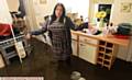 KITCHEN misery . . . Lisa Watson in her flooded home in Chew Valley Road 