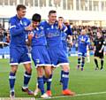 CENTRE OF ATTENTION . . . Ryan Flynn is mobbed by Lee Erwin (left) and Billy Mckay after putting Athletic in front
