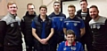 NUMBER one fan . . . Nathan (front, seated) with Latics players and staff who visited him in hospital last month