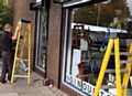 Company Alpine Security Systems install free roller shutters at Dr Kershaw's Hospice Shop, Chadderton Precinct, Middleton Road, following a break in during October which left the shop with thousands of pounds of damage
