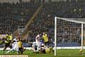 BACK OF THE NET . . . defender Cameron Burgess can't miss as he slots home for Athletic