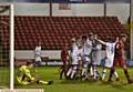 IN FRONT: Cameron Burgess (second left) is mobbed by his team-mates after putting Athletic in front at the Banks's Stadium last night. 