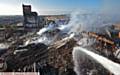 Maple Mill still smoking after last week's fire. PIC shows pics taken from a fire appliance's hydraulic platform. 