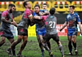 OLDHAM players, spearheaded by Danny Langtree (left), gang up to halt a Barrow attack.