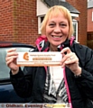 Angela Armitage with the car stickers she and friend Carole Aitken have funded in memory of their husbands Eric and Geoff