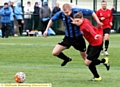 running game . . . Avro’s Mike Stockdale (left) and his AFC Monton rival race for the ball. 