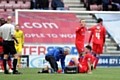 PAINFUL BLOW . . . Anthony Gerrard receives treatment to his knee before leaving the field. 