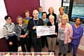 CANCER boost . . . Daniel Poole, The Christie fundraising manager, receives the cheque from Mildred Taylor, the committee’s longest-serving member