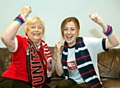 Charity volunteer Sheila Crompton and senior cancer awareness nurse Jessica Turner put aside football allegiances to unite for World Cancer Day