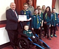 READY to go camping... Dylan Bradley in his new wheelchair, with Ian Whitehead (left, Charity Steward for Salford District Freemasons) presenting patrol leader George Symons with a cheque for £1,500