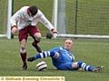 ON THE SLIDE . . . Diggle’s Keith Martin (right) tackles Heyside’s James Leonard. PICTURE: TIM BRADLEY.