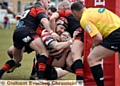 Oldham’s Michael Ward is held up just short of the line by a clutch of Kells defenders. PICTURE by TIM BRADLEY
