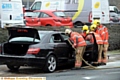 FIREFIGHTERS work on the damaged Mercedes