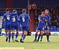 YOU BEAUTY: defender Anthony Gerrard grabs hold of Mike Jones after the midfielder’s match-winner against Chesterfield. 