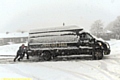 SNOW going . . . a van needs a push in Higginshaw Lane, Oldham. 