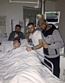 GET WELL SOON . . . Ellis is flanked by friends and relatives at Salford Royal Hospital