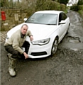 Ian Crowther has to drive over deep potholes every time he leaves his home