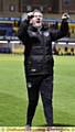 John Sheridan celebrating with the travelling fans