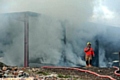 A firefighter at the fire on Round Hill Farm, Dobcross.