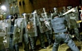 Police face a club-wielding “rioter” during the public order training session